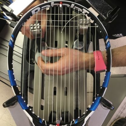 Tennis racquet being strung in our Calgary store.